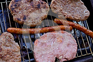 Traditional serbian barbecue rostilj  homemade sausages and burgers. Preparing a barbecue on a grill, outdoor roasting meat. Tra photo