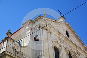Traditional shoes hang up and church architecture in Chiado District, Lisbon