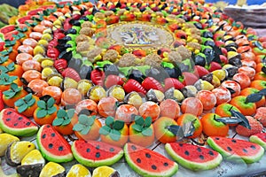 Traditional Sicilian frutta martorana assortment made of almond paste shaped in various fruits and veggies photo