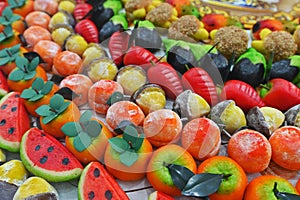 Traditional Sicilian frutta martorana assortment made of almond paste shaped in various fruits and veggies photo