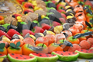 Traditional Sicilian frutta martorana assortment made of almond paste shaped in various fruits and veggies photo