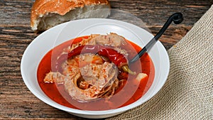 Traditional Slovak tripe soup on rustic wood table