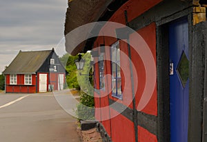 a traditional small,red,danish framehouse in summer in Bornholm with blue sky