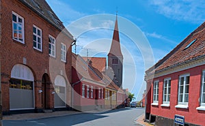 a traditional small,red,danish framehouse in summer in Bornholm with blue sky