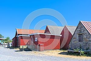 a traditional small,red,danish framehouse in summer in Bornholm with blue sky