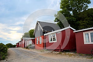 a traditional small,red,danish framehouse in summer in Bornholm with blue sky