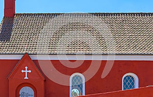 a traditional small,red,danish framehouse in summer in Bornholm with blue sky photo