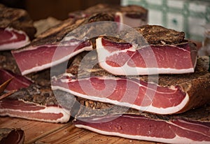 Traditional smoked speck sliced on site during the