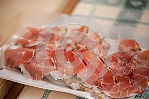 Traditional smoked speck sliced on site during the