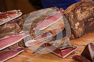 Traditional smoked speck sliced on site during the