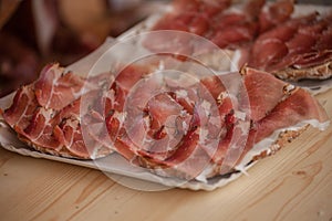 Traditional smoked speck sliced on site during the