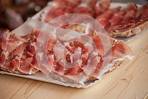 Traditional smoked speck sliced on site during the