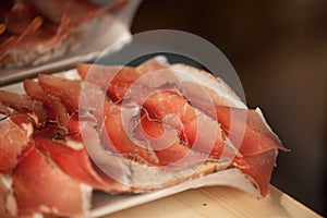 Traditional smoked speck sliced on site during the