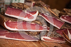 Traditional  smoked speck sliced on site during the