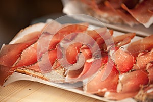 Traditional smoked speck sliced on site during the