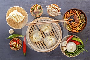 Traditional snacks of Chinese cuisine dim sum - dumplings, spicy salads, vegetables, noodles, steam bread