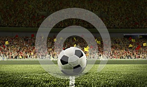 Traditional soccer football ball on grass of football field at crowded stadium with spotlight. Concept of sport, art