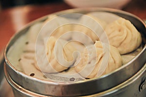 Traditional soup dumpling Xiao Long Bao is a popular Chinese dim sum steamed in bamboo steamers.