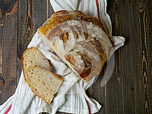 Traditional sourdough bread, sliced on a wooden board, close-up view