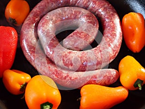 Traditional South African boerewors with red and yellow peppers