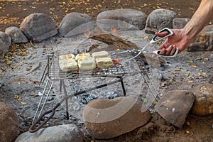 Traditional South African braai broodjies cooked outside over an open fire