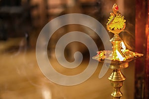 Traditional south indian brass oil lamp `Nilavilakku `. During events like housewarming, This picture is taken during a festival