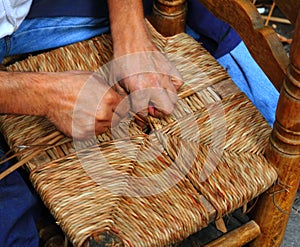 Traditional spain reed chair handcraft man hands