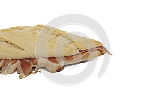 Traditional Spanish bocadillo ham sandwich with a crusty bread isolated on a white background