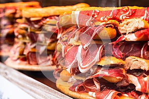 Traditional Spanish bocadillos laid out in a slide on a shop window photo