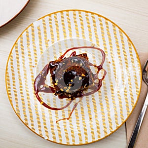 Traditional spanish dessert Tarta de zanahoria. Slice of carrot cake with chocolate syrup photo