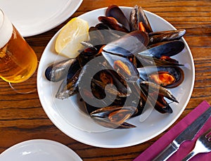 Steamed mussel served with lemon photo