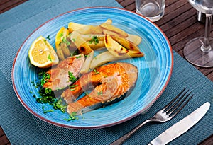 Traditional spanish food, salmon con pimiento patata, roasted salmon with potato and lemon