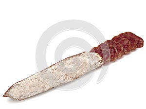 Traditional Spanish Fuet thin dried sausage with slices, Close-up, isolated on a white background