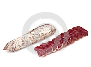 Traditional Spanish Fuet thin dried sausage with slices, Close-up, isolated on a white background