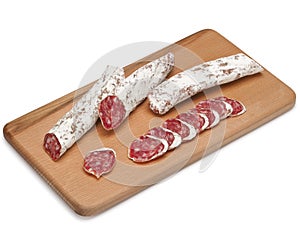 Traditional Spanish Fuet thin dried sausage with slices, Close-up, isolated on a white background