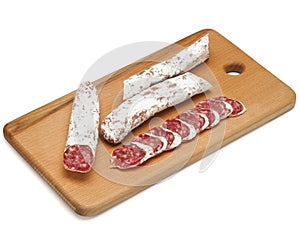 Traditional Spanish Fuet thin dried sausage with slices, Close-up, isolated on a white background