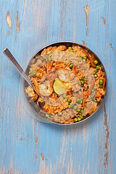 Traditional spanish paella dish with seafood, peas, rice and chicken