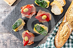 Traditional Spanish pintxos on wooden table