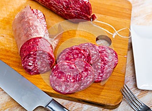 Traditional spanish salchichon sausage on wooden table