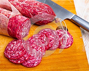 Traditional spanish salchichon sausage on wooden table