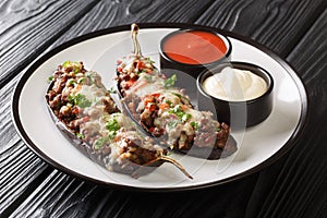 Traditional Spanish stuffed eggplant berenjenas rellenas close-up in a plate. Horizontal