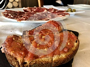 Traditional spanish tapas, bread with tomato sauce, pan con tomate photo