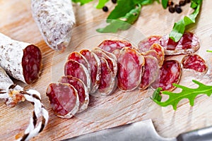 Traditional spanish thin salami sausage Fuet, sliced