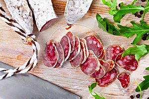 Traditional spanish thin salami sausage Fuet, sliced