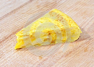 Traditional spanish tortilla on a wooden table. Typical dish made with eggs, potatoes and onion