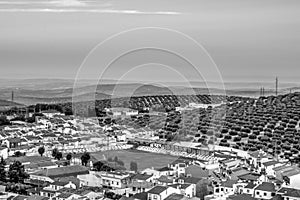 Traditional Spanish whitewashed village with mountain and ruined castle on the sumit. Monochrome black and white