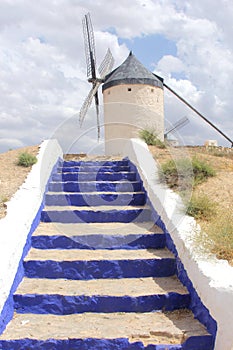 Picturesque Spanish mill with blue stairs along Don Quichot route,Consuegra, Spain photo