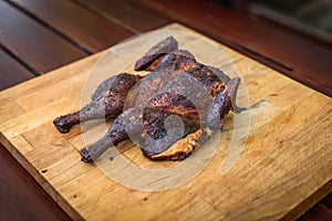 Traditional spatchcocked barbecue chicken al mattone on charcoal grill photo