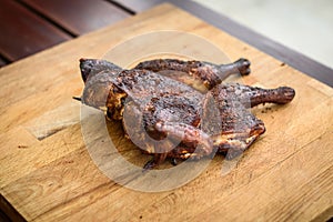 Traditional spatchcocked barbecue chicken al mattone on charcoal grill photo