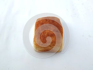 A traditional square loaf of bread is  on a white background. bread  on a white background.